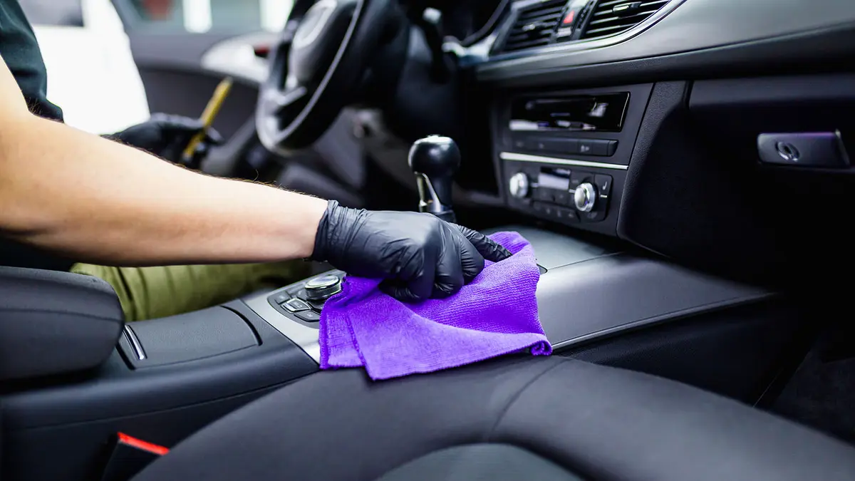 A person cleaning the interior of a car.